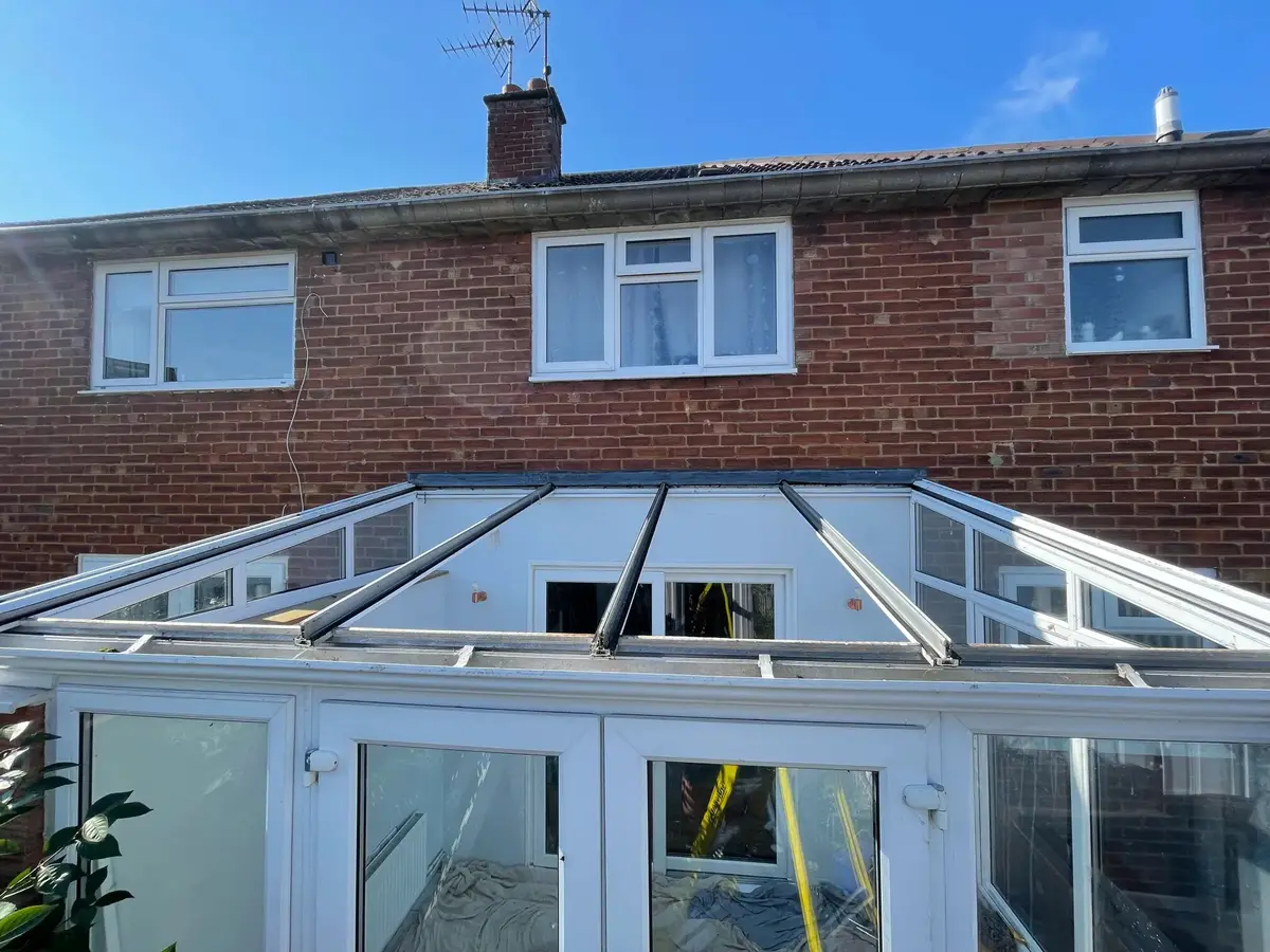 Lean-to conservatory roof stripped back to its frame, ready for insulated panels