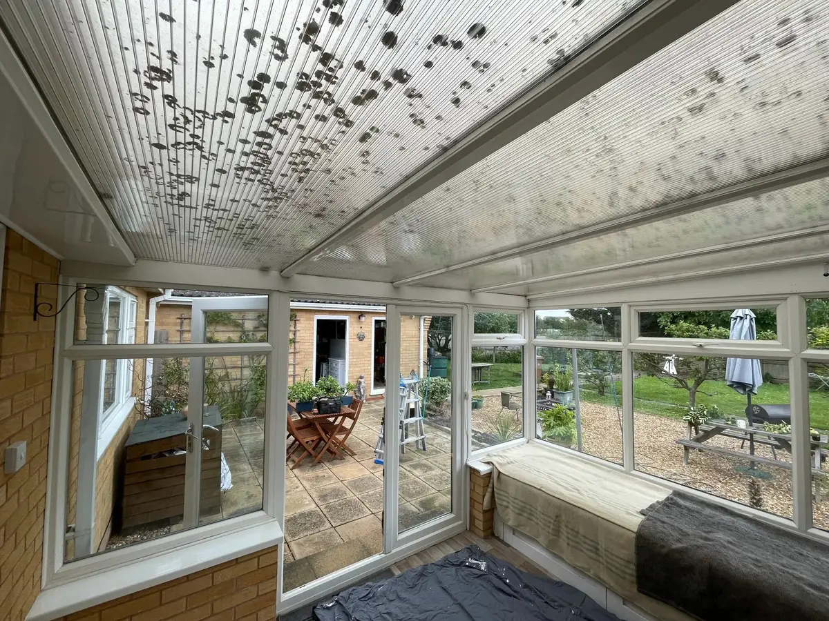 The same kind of conservatory before, with an old polycarbonate roof