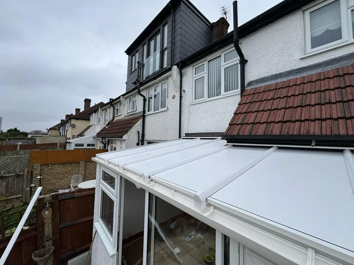 New white insulated panel lean-to roof at the back of a terraced house
